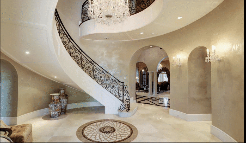 The grand staircase at 11 Paradise Point in Sugar Land 
